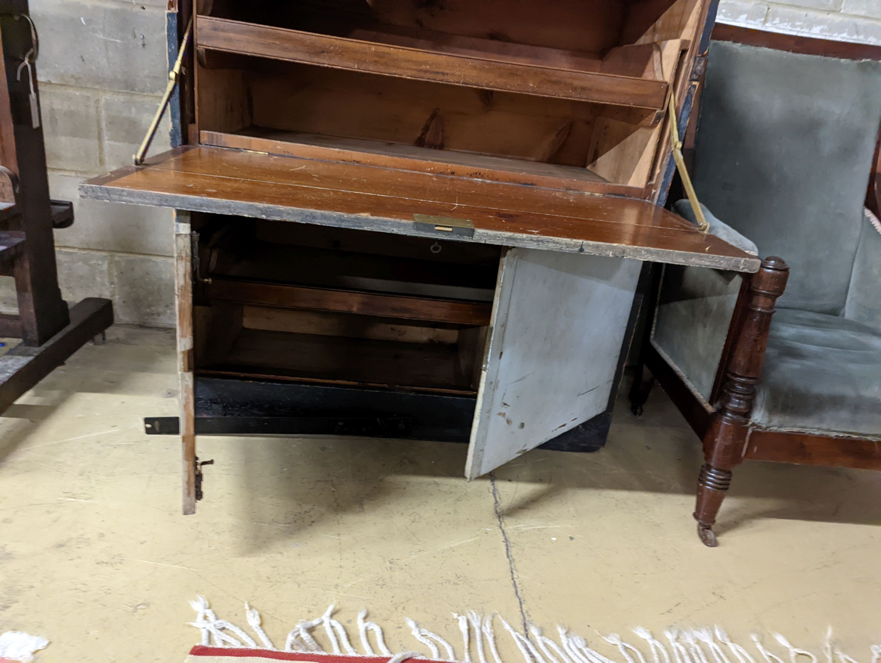 An early 20th century painted and stained pine campaign chest - owners name plate for W.E Higham, R.N. , retailers name plate Gieve’s. W-106cm, D-54cm, H-114cm.